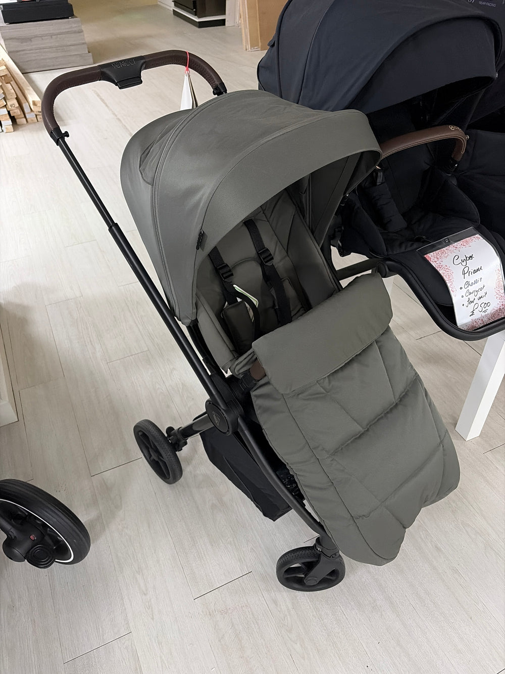 Sage green stroller with padded seat and hood, front view