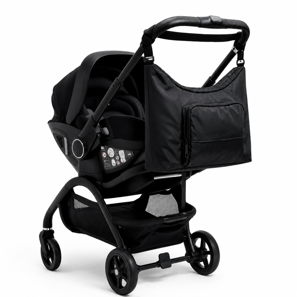 Black baby changing bag with roomy main compartment and front zip pocket.