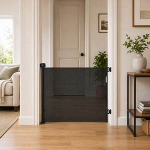 Black fabric retractable stair gate with mounted posts and closed mesh barrier