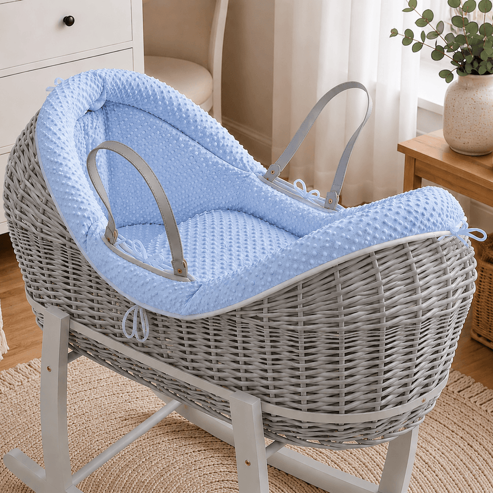 Blue dimple Moses basket bedding set: textured pad with fitted side straps and bows.