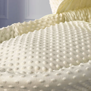 Cream dimple quilted Moses basket mattress with raised textured pattern