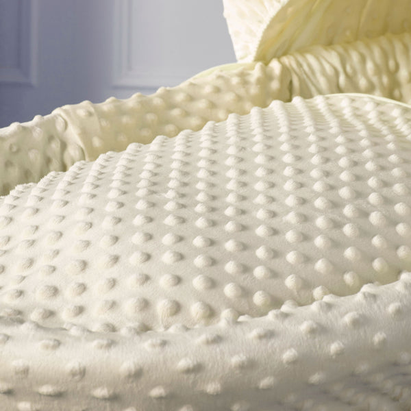 Cream dimple quilted Moses basket mattress with raised textured pattern