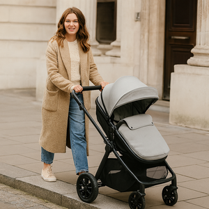 Sage-green stroller with black frame and seat, shown outdoors with carry handle