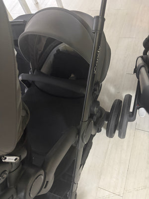 Grey pushchair carrycot with canopy and large wheels, close side angle