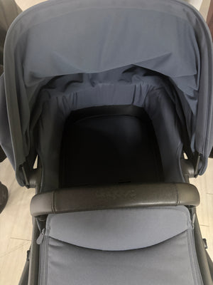 Bugaboo Fox 5 stroller canopy over dark seat and padded base in stormy blue