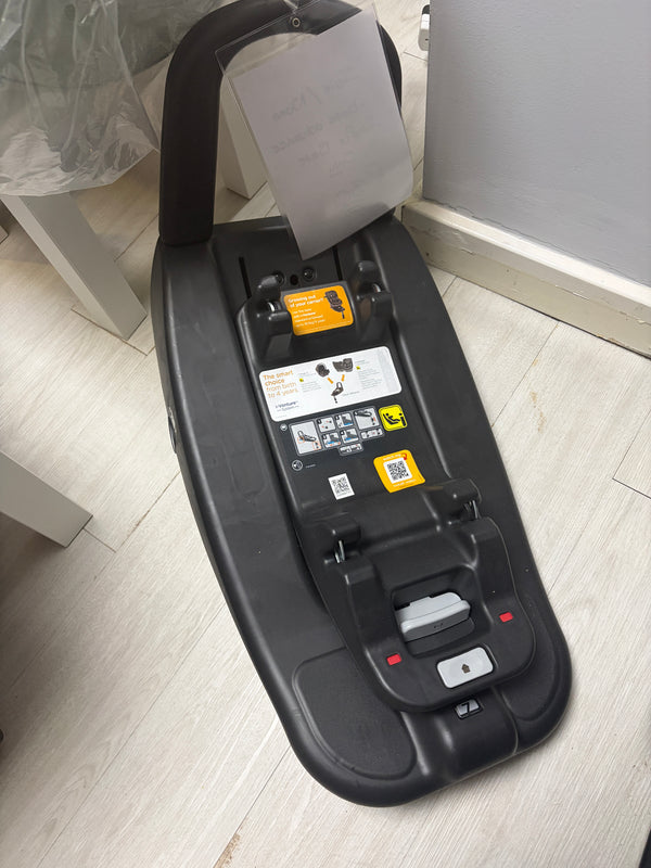 Black car seat base with ISOFIX connectors and control labels