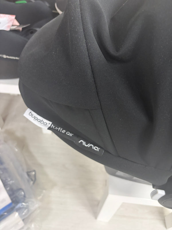 Black car seat side closeup with Bugaboo Turtle Air and Nuna branding