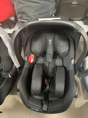 Red Kite newborn car seat with black padded inserts and 5-point harness, front view