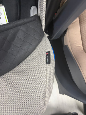 Newborn car seat insert with dark gray quilted panel and Venicci label