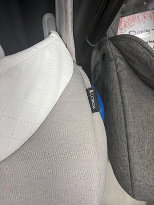 Cream newborn car seat fabric close-up with VENICCI label