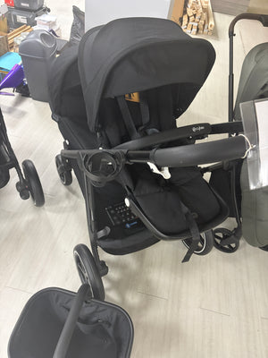 Double stroller with two black carrycots, rounded canopies and front wheel details