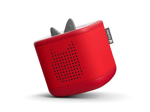 Angled view of red Toniebox 2 audio player showing its perforated speaker grille and gray ears