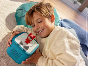 Toniebox 2 in tropical teal held by a child with a red character figure on top
