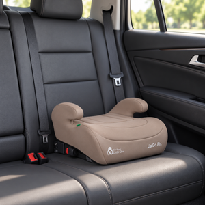 Latte beige UpGo Fix booster seat installed in car with padded armrests and sides.