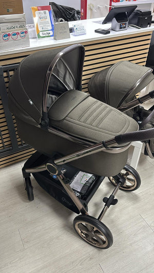 Gray stroller with cushioned toddler seat and canopy, curved handlebar, and black wheels