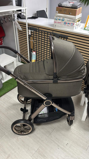 Gray stroller with bassinet and canopy, silver frame accents, and large black wheel hubs