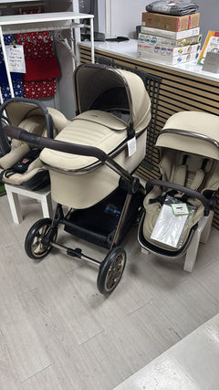 4-in-1 stroller bundle with two beige seats and dark chassis