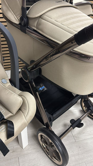 Beige stroller seat base and handle bar detail with wheels