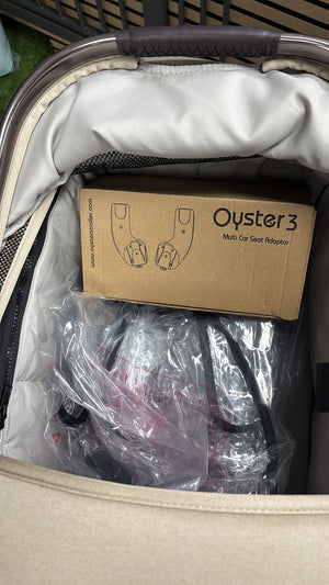 Packaged stroller accessories inside a clear bag with cardboard insert