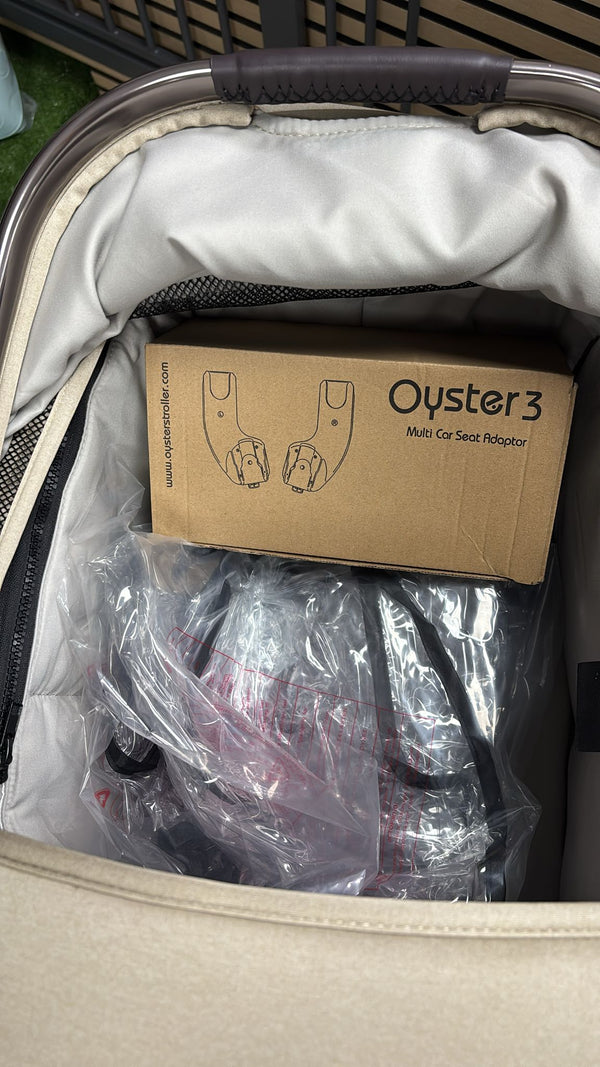 Packaged stroller accessories inside a clear bag with cardboard insert