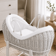 White wicker baby Moses basket with white stand and padded pod liner