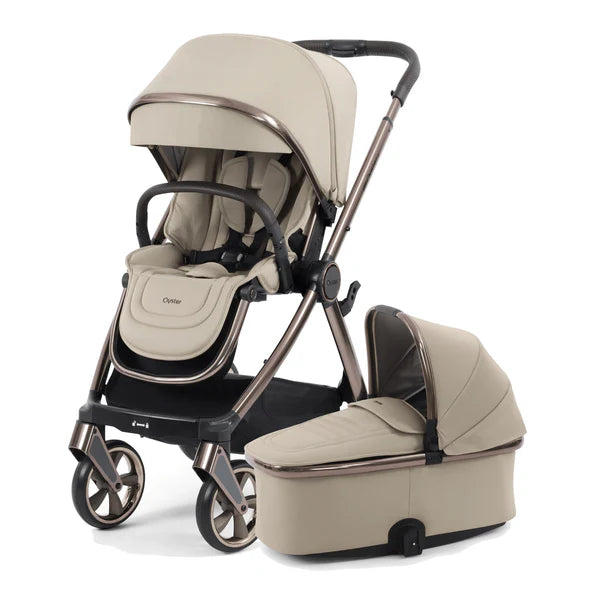 Beige 4-in-1 stroller with bassinet and seat modules, three-quarter view