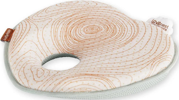 Contoured baby head support with orange line print, central opening and pale green edging